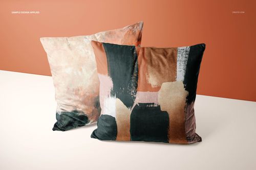 PSD mockup displaying a pair of velvet cushion covers with bold, painterly patterns in black, peach, and beige colors.