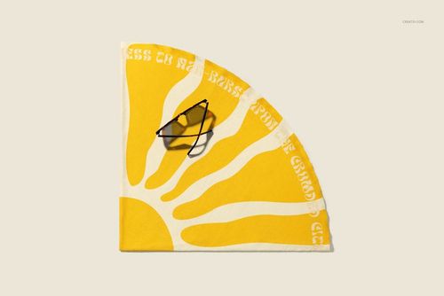 Round microfiber beach towel mockup in yellow and white sunburst pattern, top view, sunglasses placed on top.