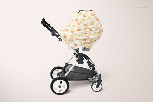 PSD mockup of a baby stroller with a patterned multi-use cover, photographed from a right-side perspective.