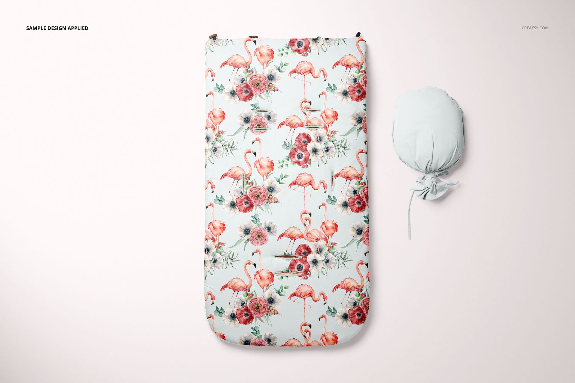 Front view of a baby sleeping bag mockup with a floral and flamingo pattern, next to a tied sleeping bag on a light background.