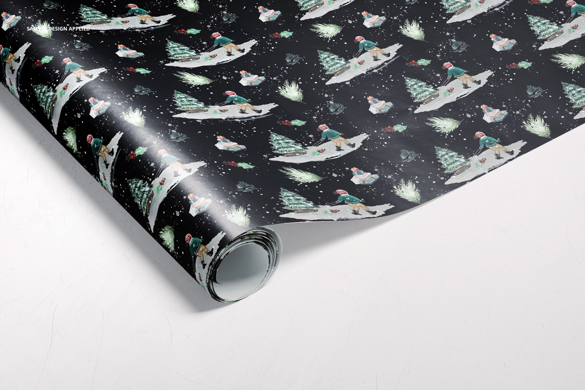 Holiday-themed wrapping paper mockup showing polar bears, decorated trees, and snow elements on a black surface.