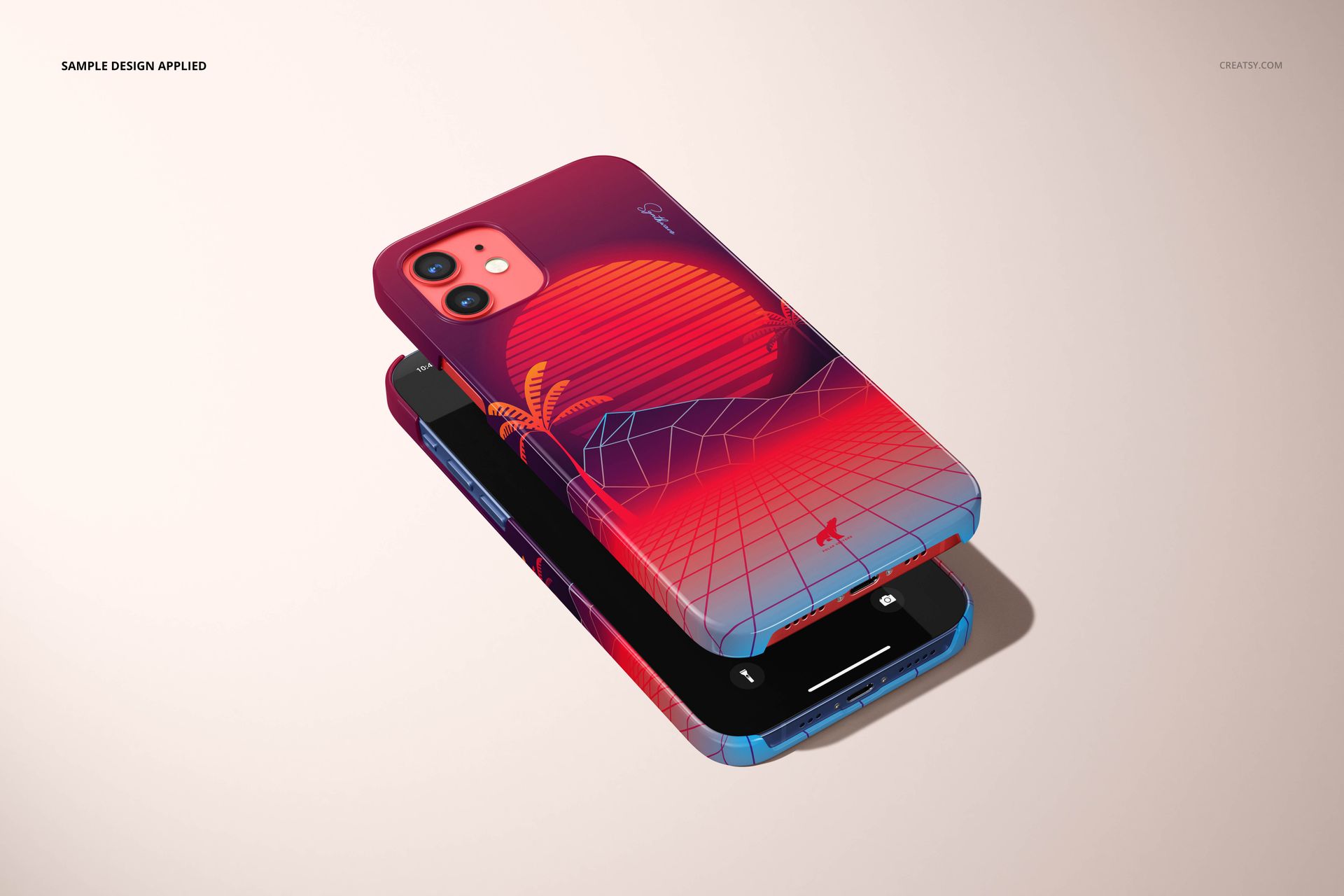 Two iPhone 12 devices with glossy snap cases in red and blue tones featuring a sunset and palm tree design, shown from an angled top view.
