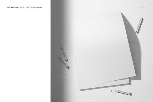 PSD mockup featuring several white pastel sticks and blank decorative paper sheets in a minimalist, overhead scene.