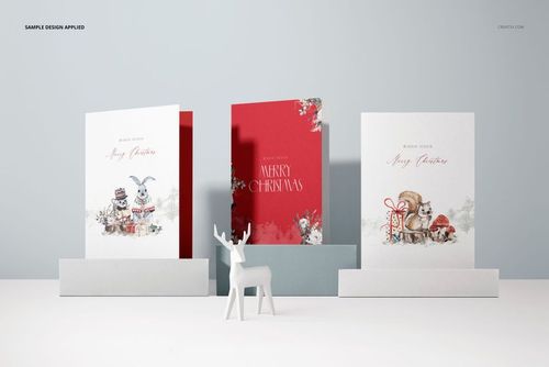 Mockup of three 5x7 stationery cards with holiday artwork, arranged side by side with a small white deer figurine.