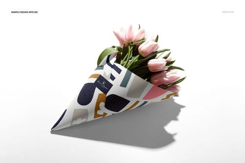 Flowers packaging cone mockup featuring pink tulips in a patterned paper cone, displayed on a white surface.