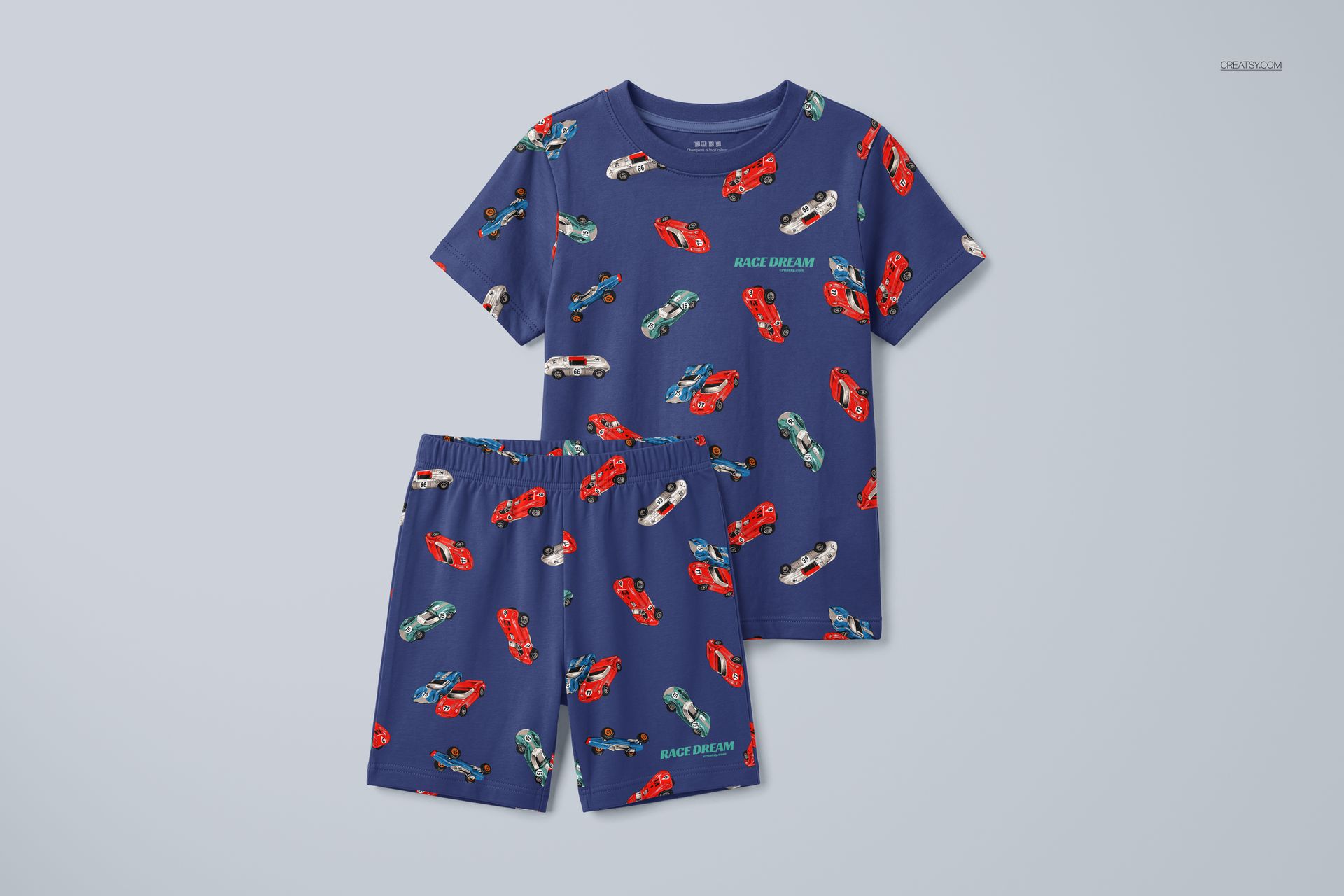 Top view of a children's pyjama mockup set with matching blue shirt and shorts decorated with small race cars.