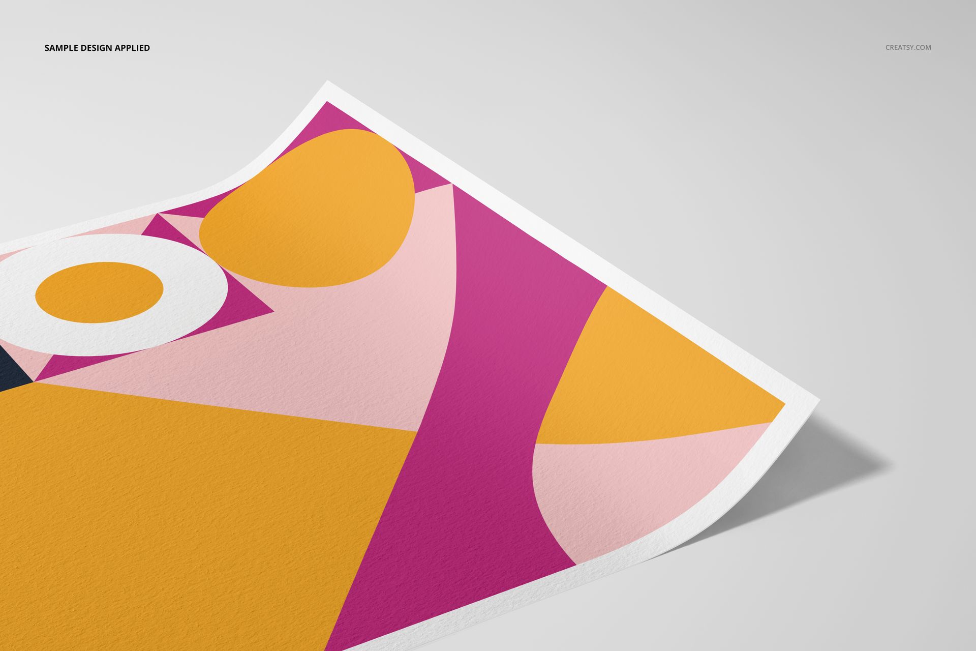 A3 fine art print mockup showing a close-up angled view of textured paper with bold geometric abstract design in yellow, pink, and white.