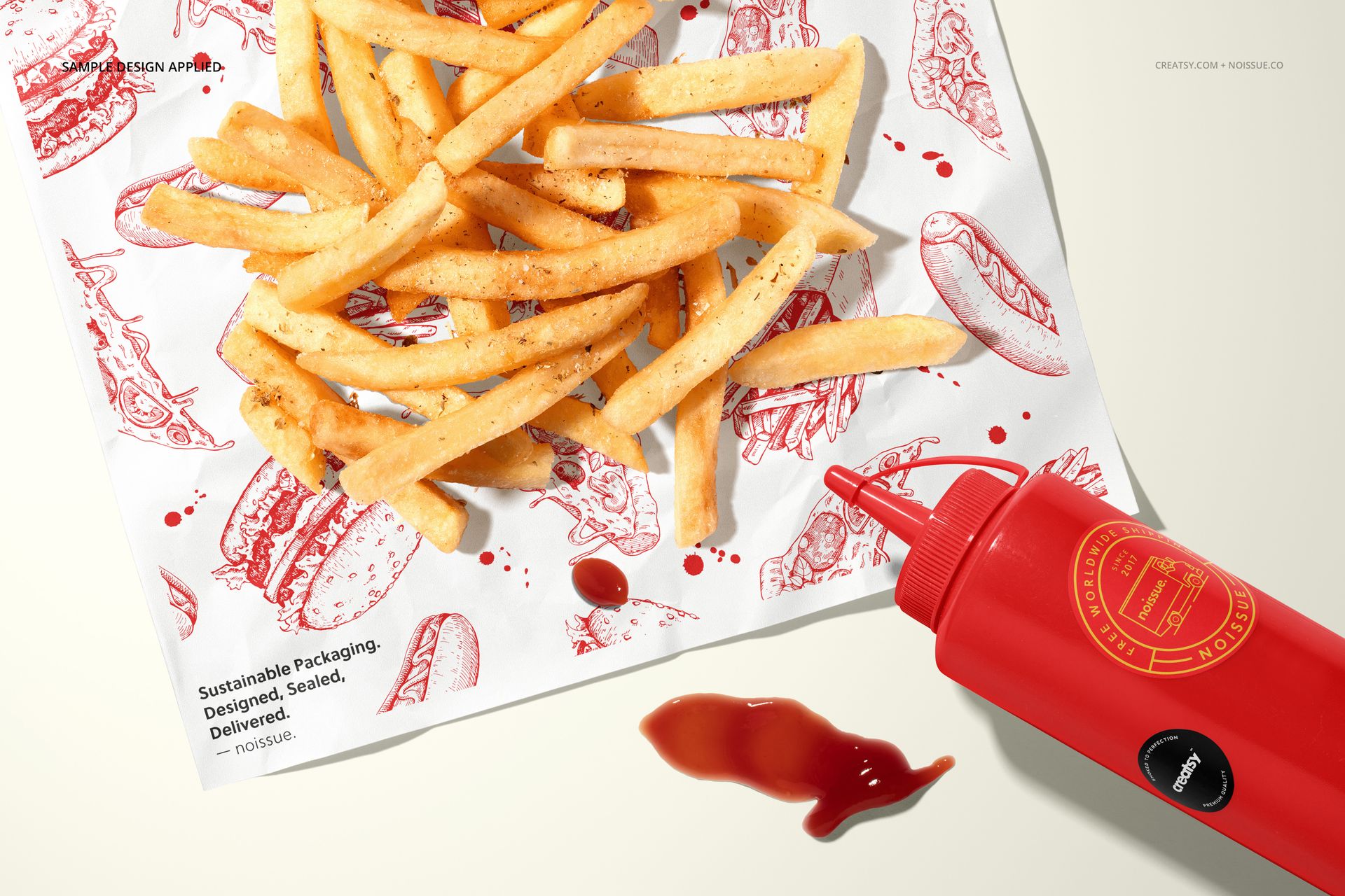 Mockup scene featuring crispy fries on patterned white paper with red food drawings and a red condiment bottle nearby.