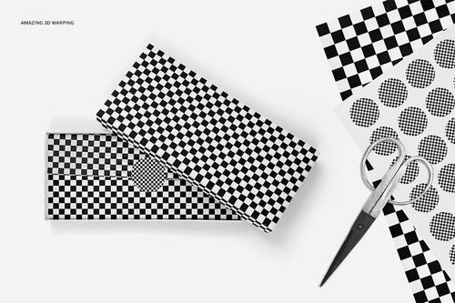 Black and white patterned tissue paper mockup featuring a gift box, loose sheets, and scissors arranged in a minimal scene.