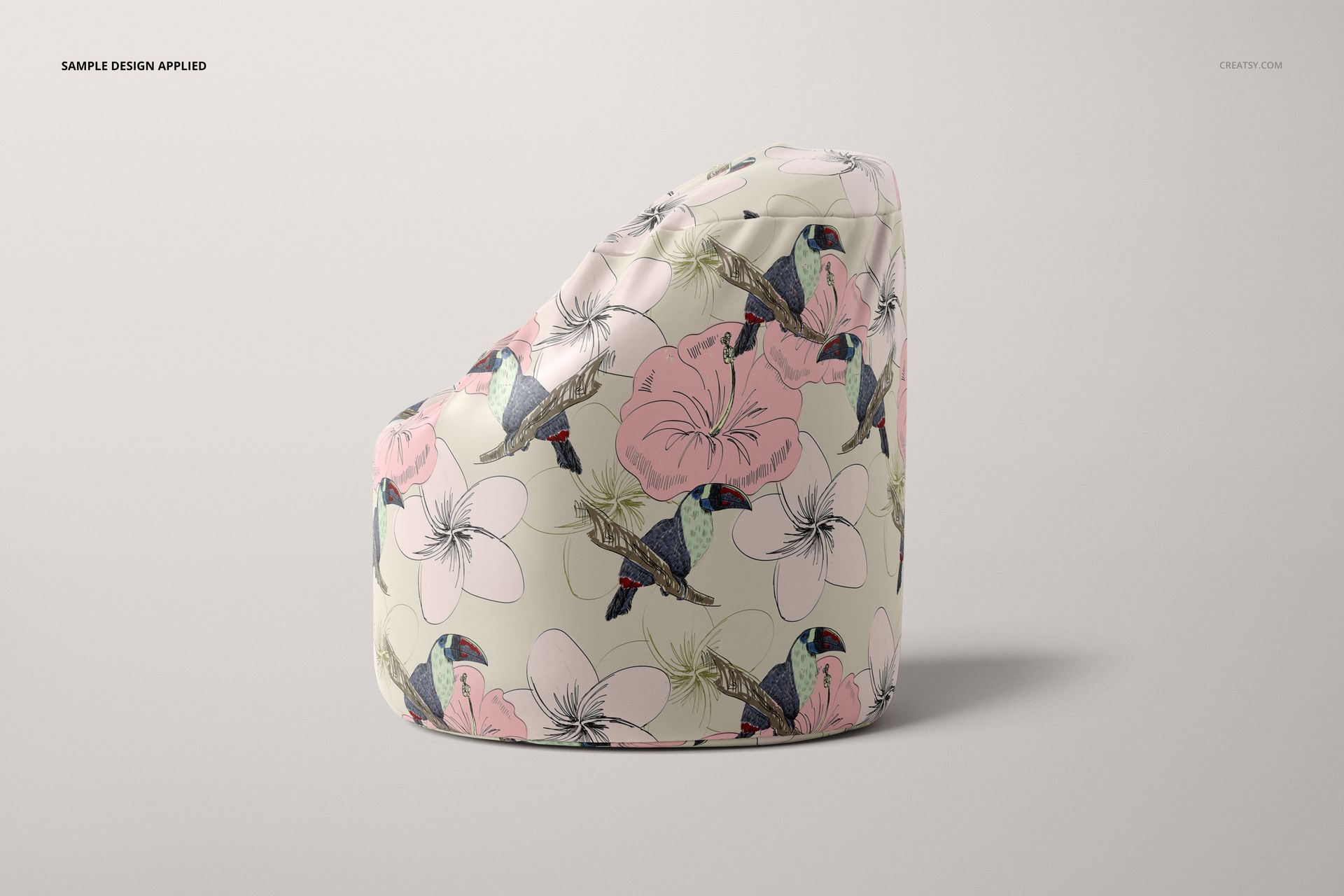 PSD mockup of an adult bean bag, shown from the side, decorated with illustrated flowers and birds in soft pastel colors.