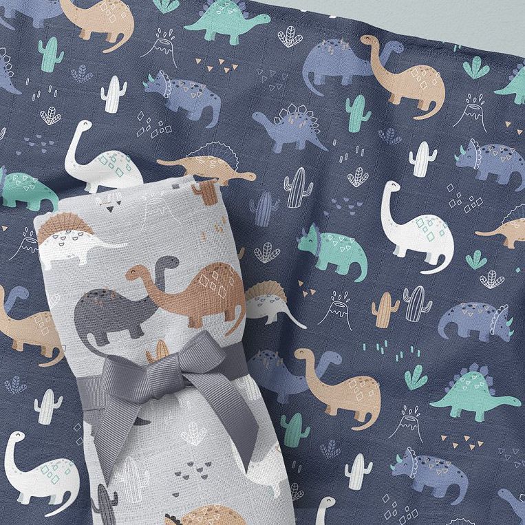 Baby muslin square nappies mockup featuring a rolled cloth with a bow and a flat cloth, both with colorful dinosaur patterns.