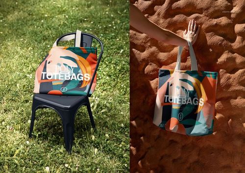 PSD mockup of a spacious canvas tote bag featuring a bold geometric design, displayed on grass and sandy background.