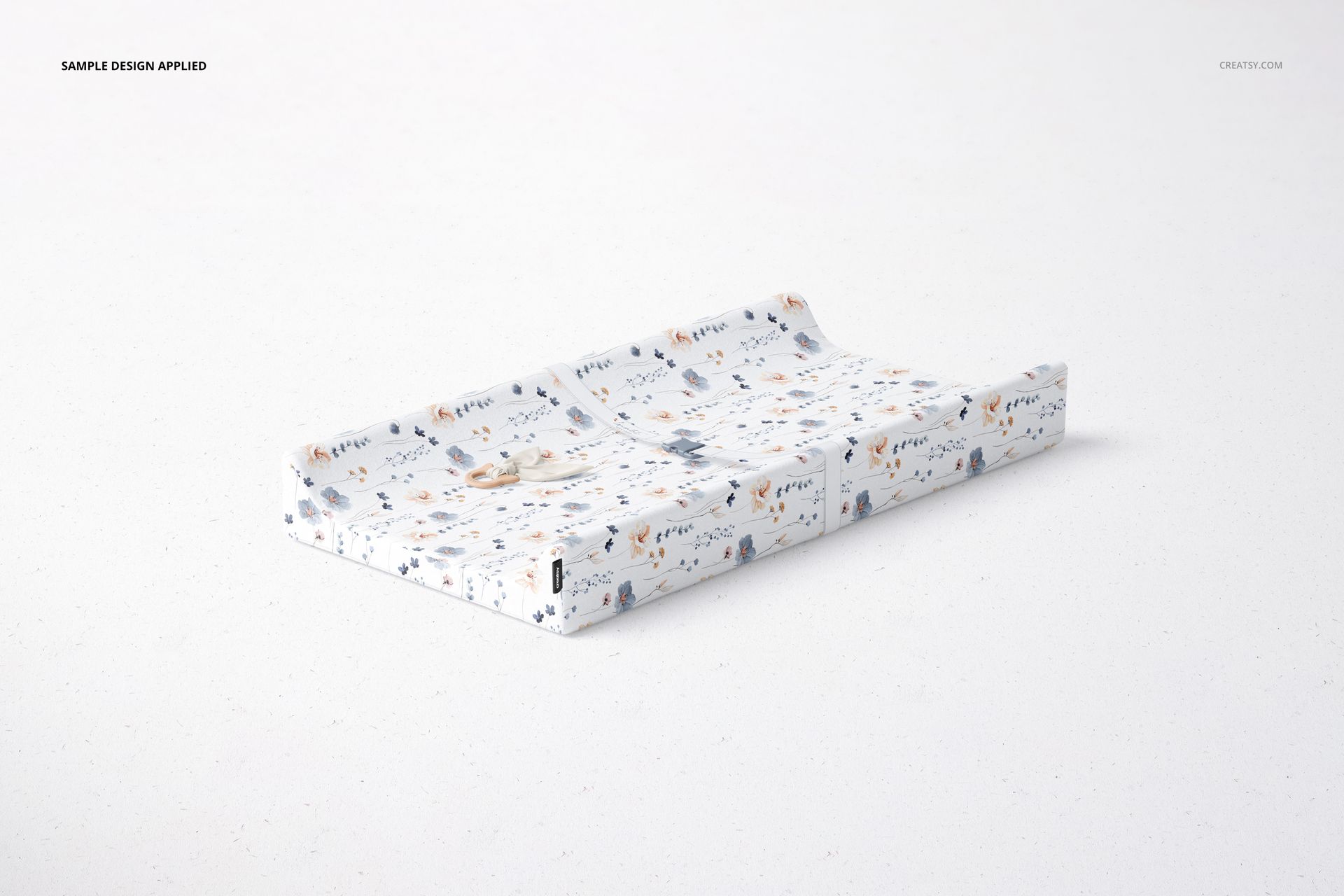 PSD mockup of a rectangular changing pad with contour shape, decorated with small animal illustrations and soft colors.