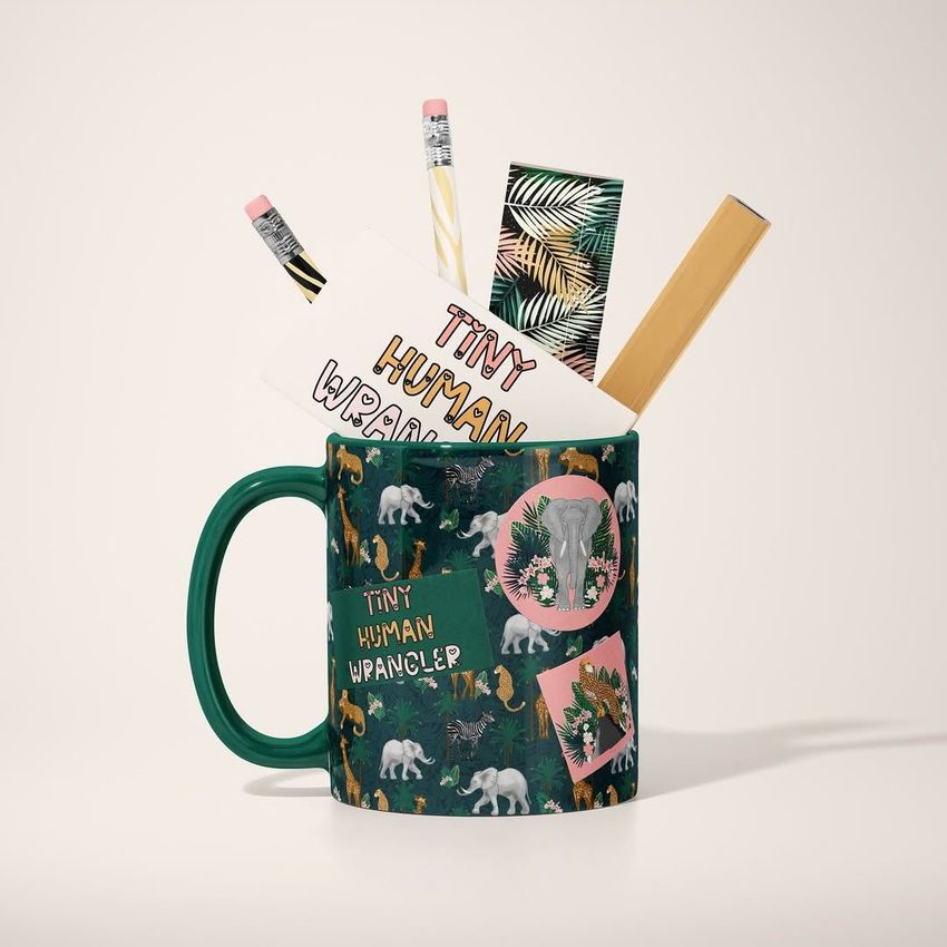 Mug mockup with a green handle featuring a jungle animal pattern, filled with pencils, a ruler, and stationery on a light background.
