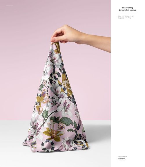 Jersey fabric mockup with a botanical and geometric print, displayed upright by a hand on a pink and white backdrop.