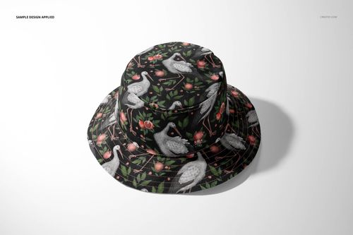 Front view of a reversible bucket hat mockup featuring a dark background with crane and floral pattern on a plain surface.
