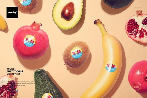 Assorted fresh fruits including pomegranate, avocado, kiwi, and banana on a beige surface, each with a round sticker mockup.