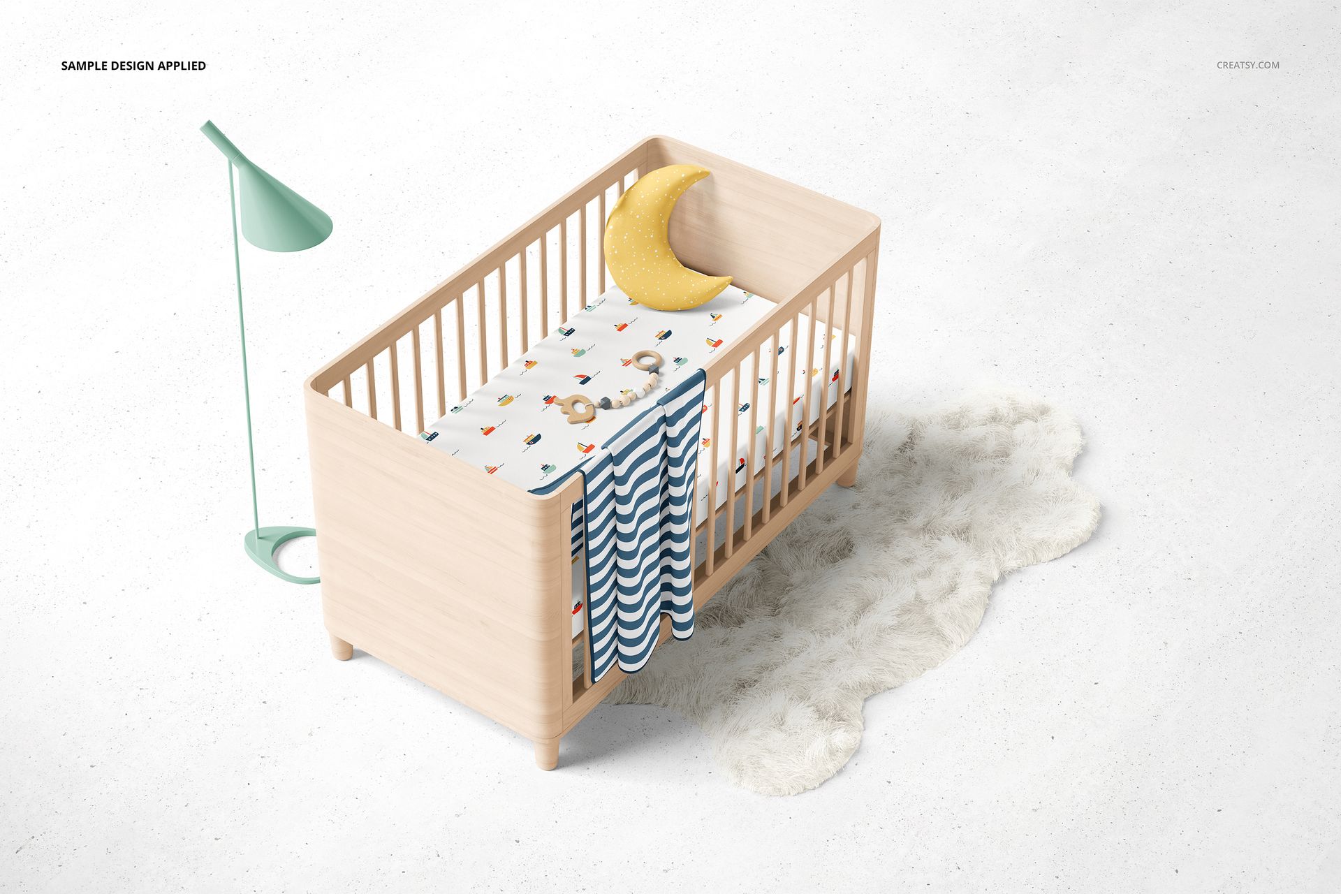 PSD mockup of a crib with a colorful fitted sheet, blue wave blanket, yellow moon cushion, and soft white rug on the floor.