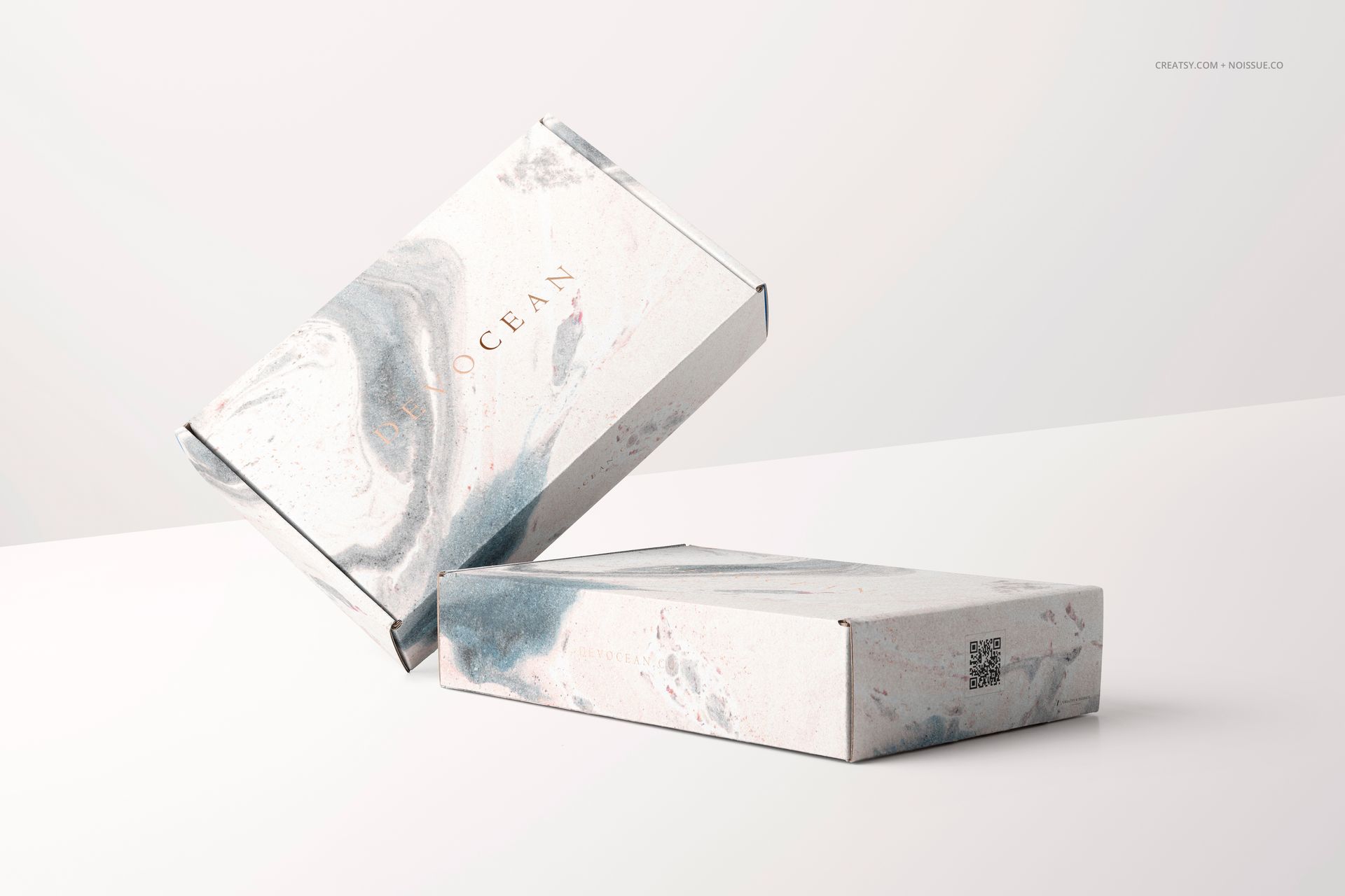 PSD mockup of two packaging boxes with a soft marble texture, one box stacked on another in a minimalist scene.