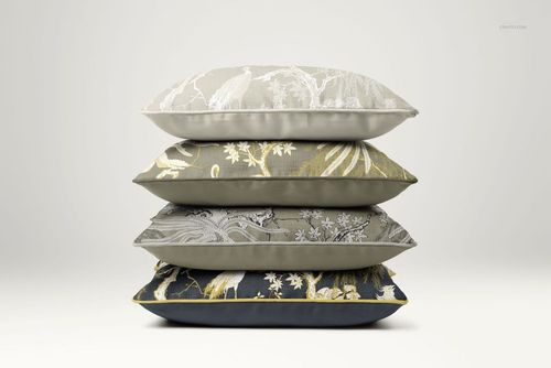 PSD mockup featuring a side perspective of stacked cushions with various floral and wildlife motifs in earthy tones.