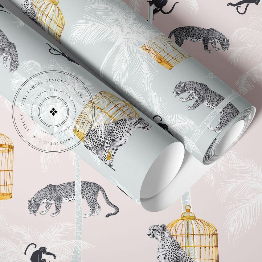 Paper wallpaper mockup featuring two rolled sheets on a flat surface with a pattern of leopards, palm trees, and gold birdcages.