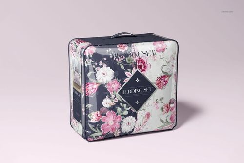 PSD mockup of a bedding packaging bag with floral design, black handle, and soft pastel backdrop.