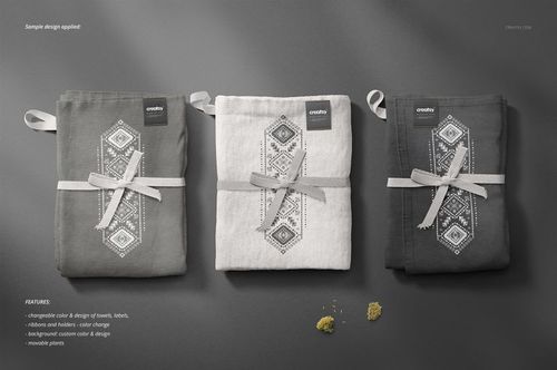 Kitchen towels mockup showing three folded towels in neutral colors, arranged side by side with decorative ribbons and labels.