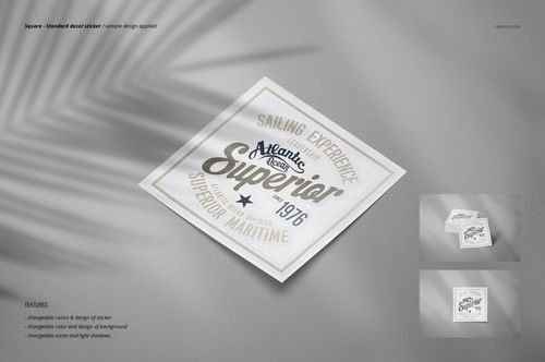 Square decal sticker mockup featuring a centered sticker with gray and beige text, shown on a light fabric background.