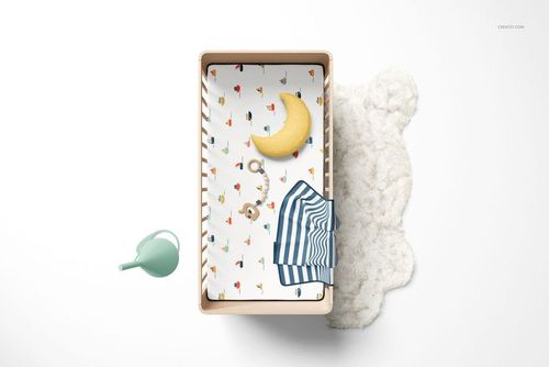 Fitted crib sheet mockup featuring whimsical designs, moon-shaped pillow, and striped sleepwear in a nursery setting.