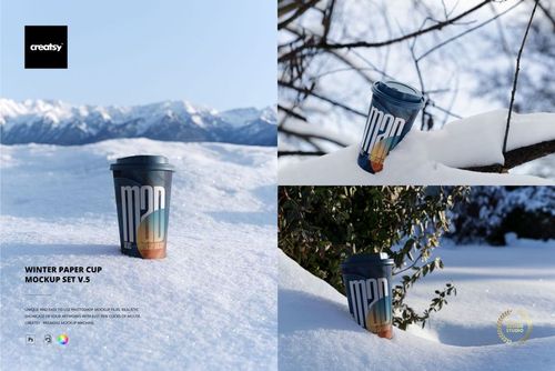 Winter paper cup mockup featuring a blue lid and colorful print, displayed on snow in front of mountain landscape.