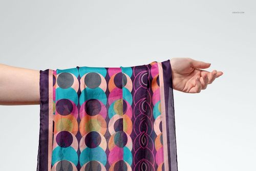 Habotai silk scarf mockup draped over an outstretched arm, featuring vibrant abstract patterns and dark borders.