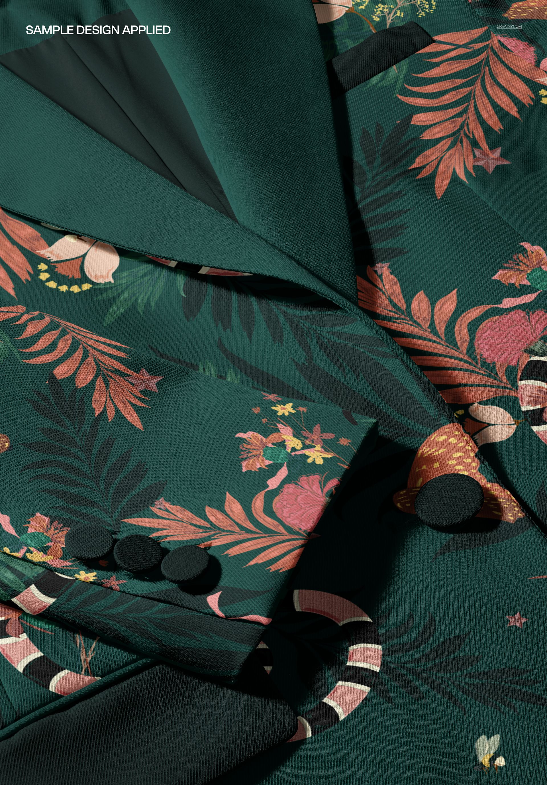 Close-up view of a women's blazer mockup featuring a dark green fabric with colorful floral and leaf patterns.