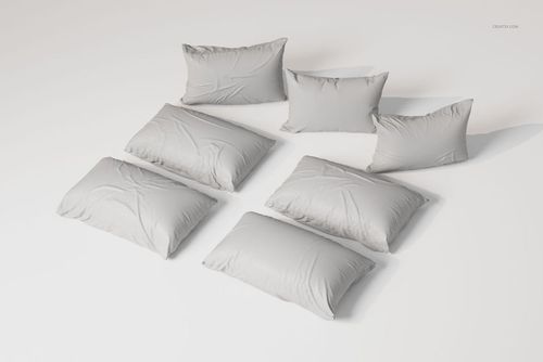 Rectangular sleeping pillows in light gray fabric arranged in two rows on a plain white surface, top view.