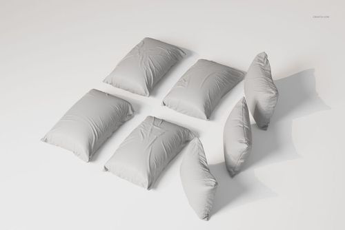 Six rectangular sleeping pillows in light gray fabric arranged on a white surface, shown from a top angle.