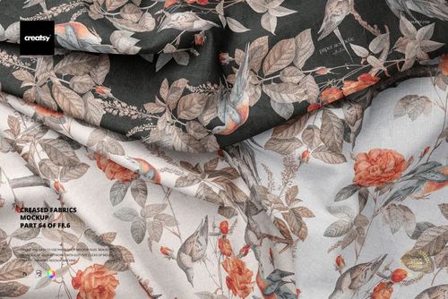 Creased fabric mockup featuring two pieces of cloth with botanical and bird patterns, shown in a close-up view.