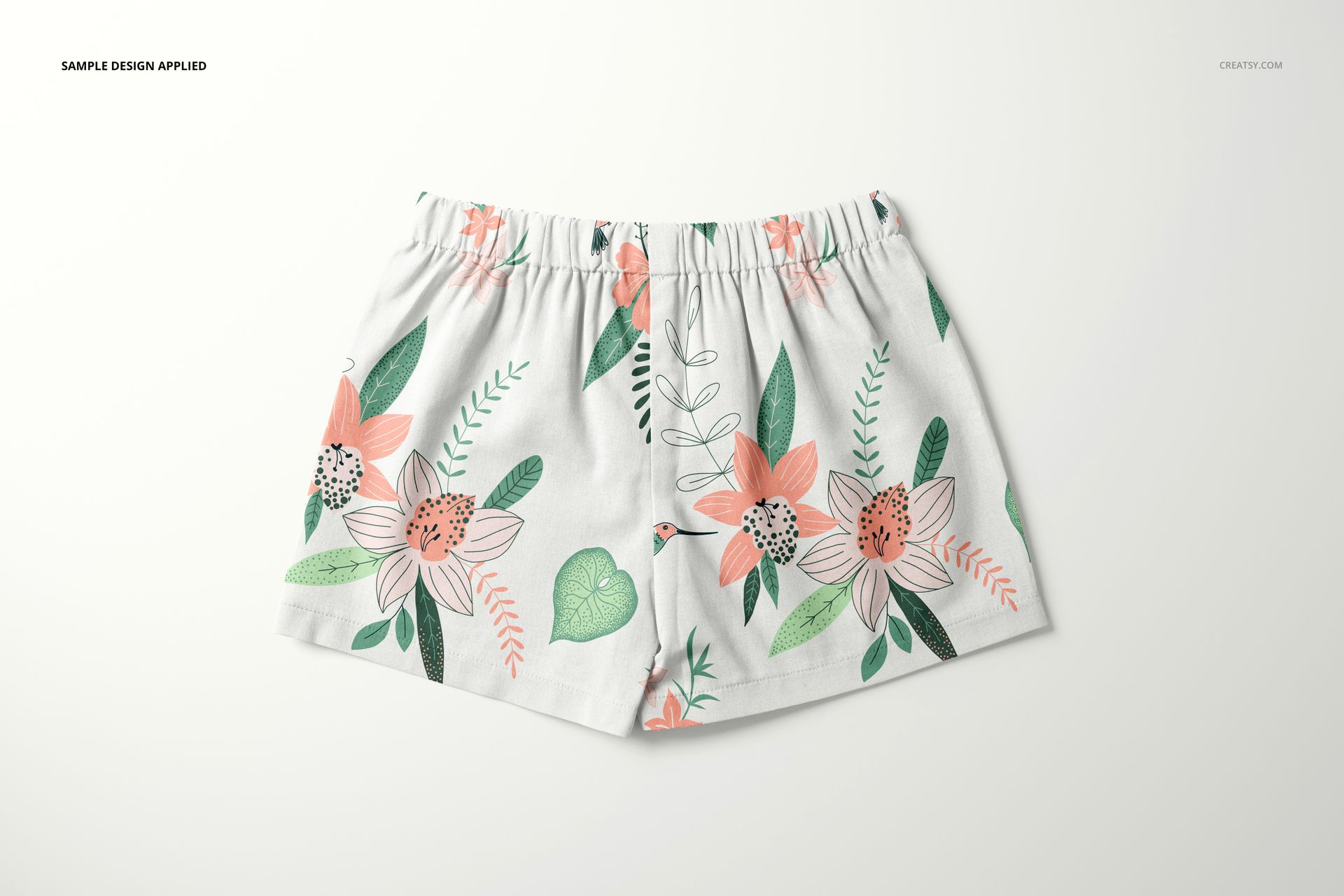 Front view of baby and kids shorts mockup with a white base and colorful floral pattern, displayed on a plain background.