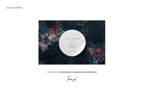 Front view of a skirted sofa with pillows placed against a dark floral wallpaper, featured in a PSD mockup scene.