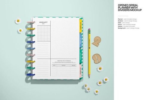Stationery mockup featuring an open planner, pencil, paper clips, and scattered daisies viewed from above on a blue background.