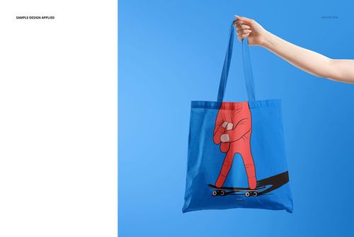Tote bag PSD mockup with a vibrant blue color and playful hand-skateboard design, displayed on a blue background.