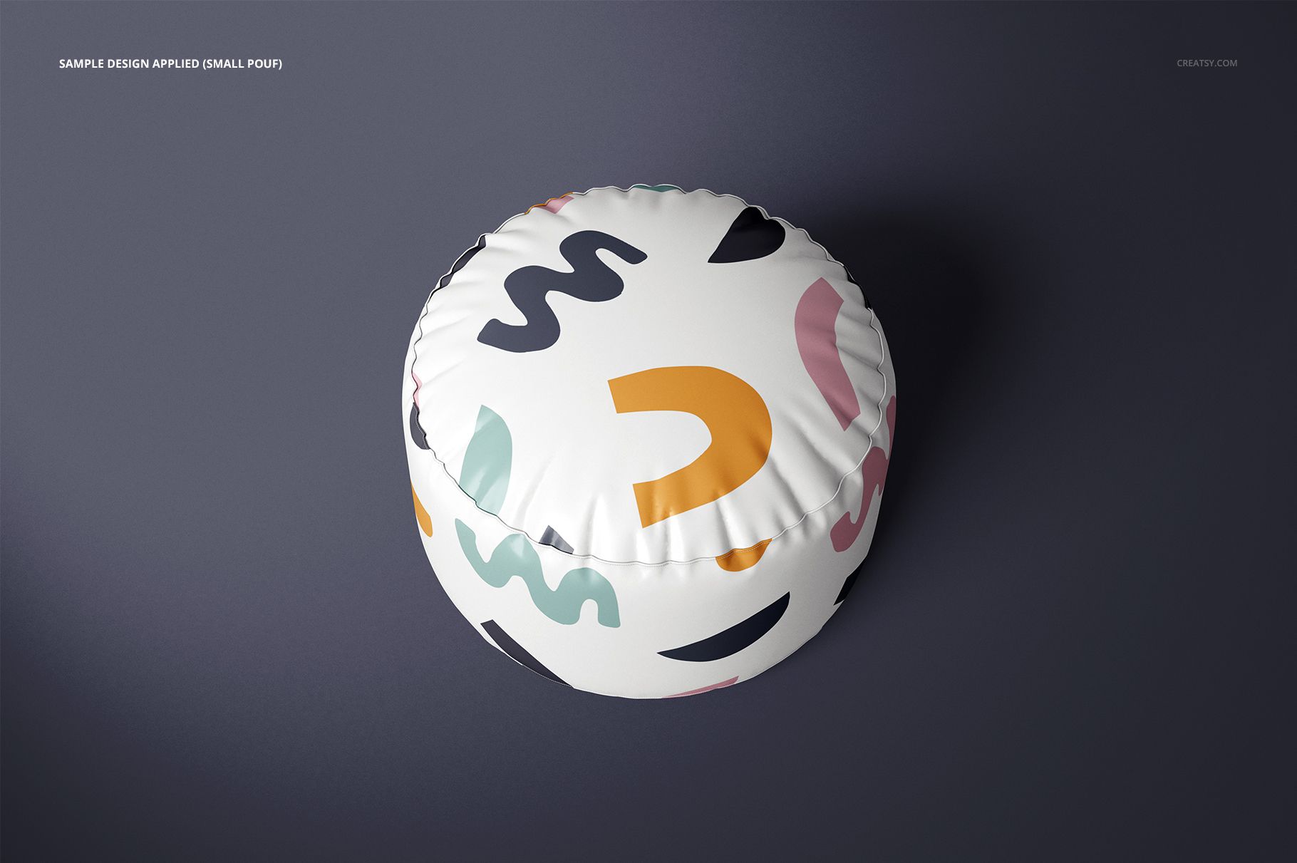 PSD mockup of a circular pouf with a white background and bold, playful shapes in various colors, top perspective.