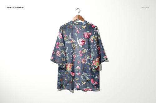 PSD mockup of a chiffon kimono featuring vibrant flowers and birds, shown from the back on a hanger with soft lighting.