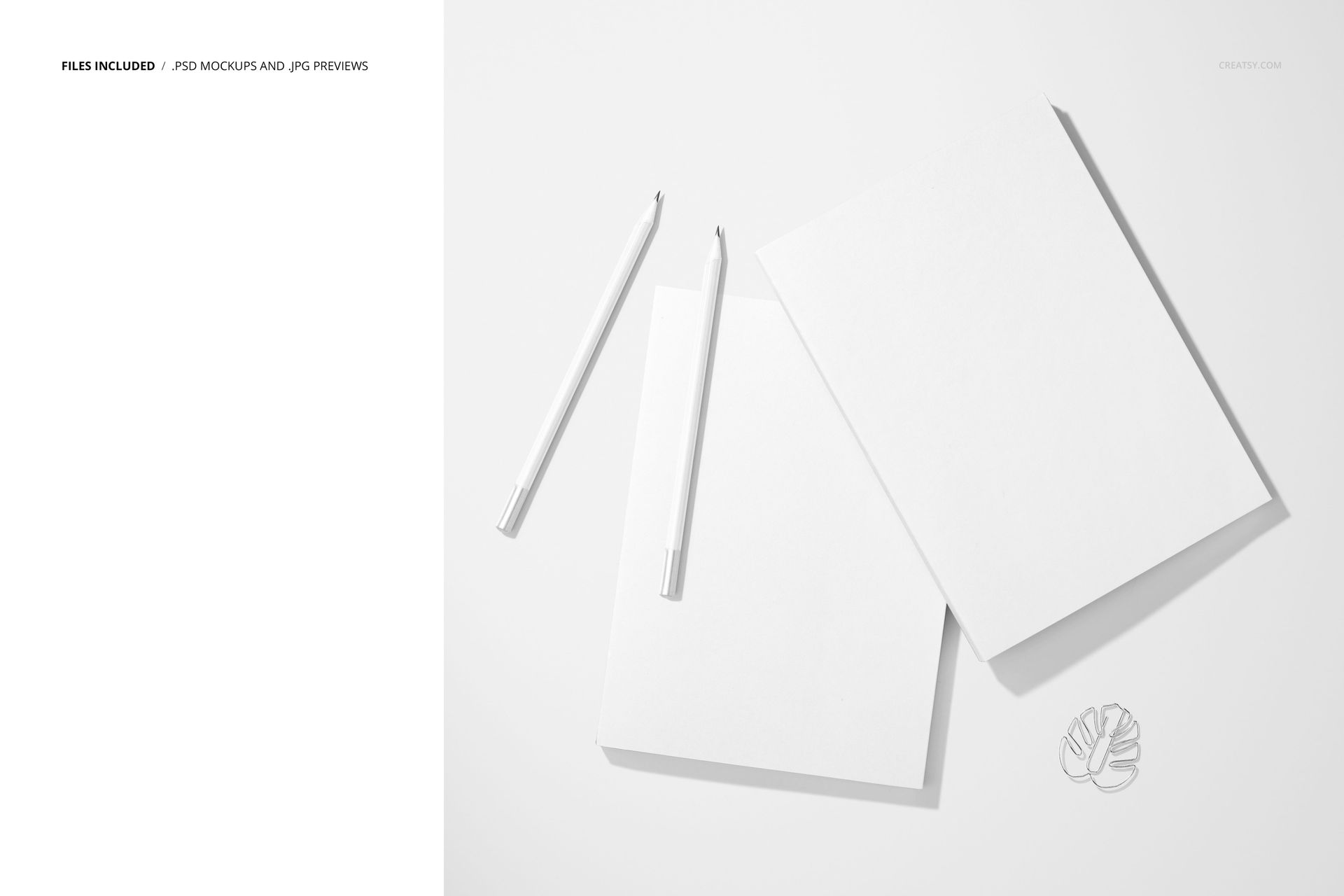Stationery mockup showing two blank planners and pencils from above, with a metal leaf-shaped paperclip on the side.
