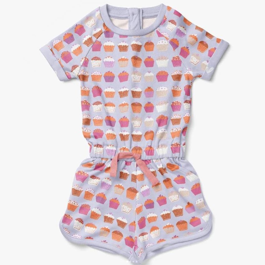 Girls cotton playsuit mockup featuring a short-sleeved romper with a cupcake pattern in pastel and warm tones on a light background.