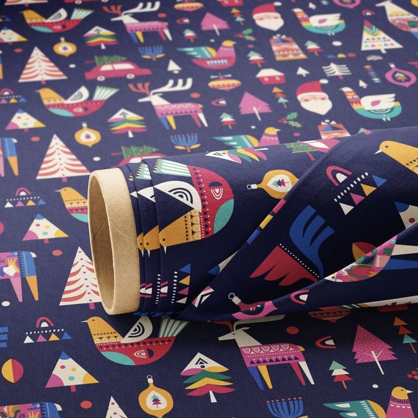 Fabric roll mockup featuring a colorful Christmas pattern with trees, ornaments, and festive icons on a dark background.