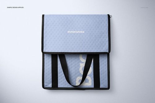 Front view of a rectangular insulated cooler bag mockup in light blue with black handles and a textured surface.