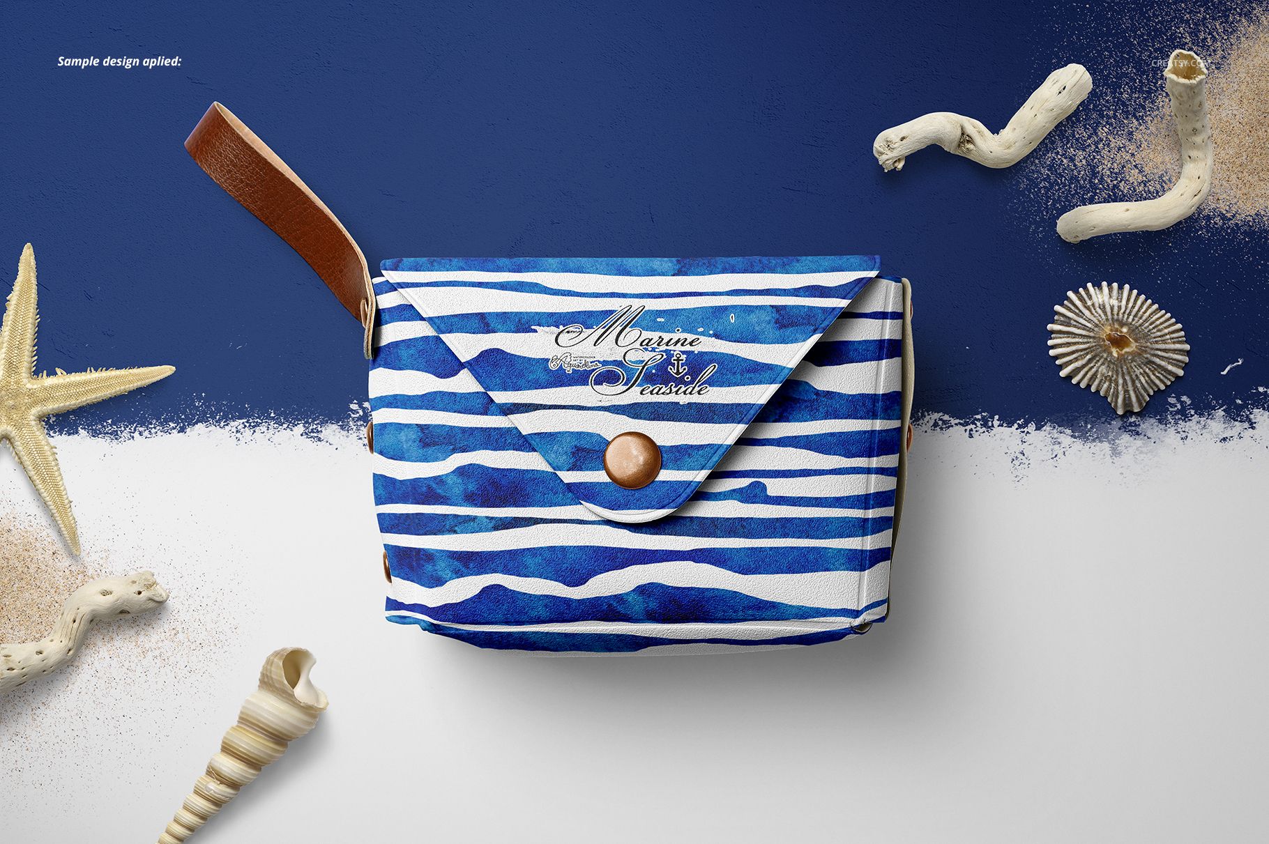PSD mockup of a little leather pouch wallet featuring a blue wave design, displayed with starfish and shells.