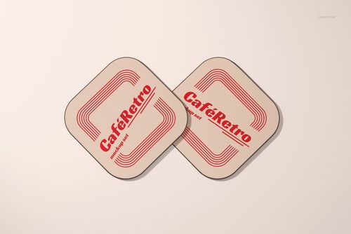 PSD mockup of two square coasters with curved corners and bold red text, arranged side by side.