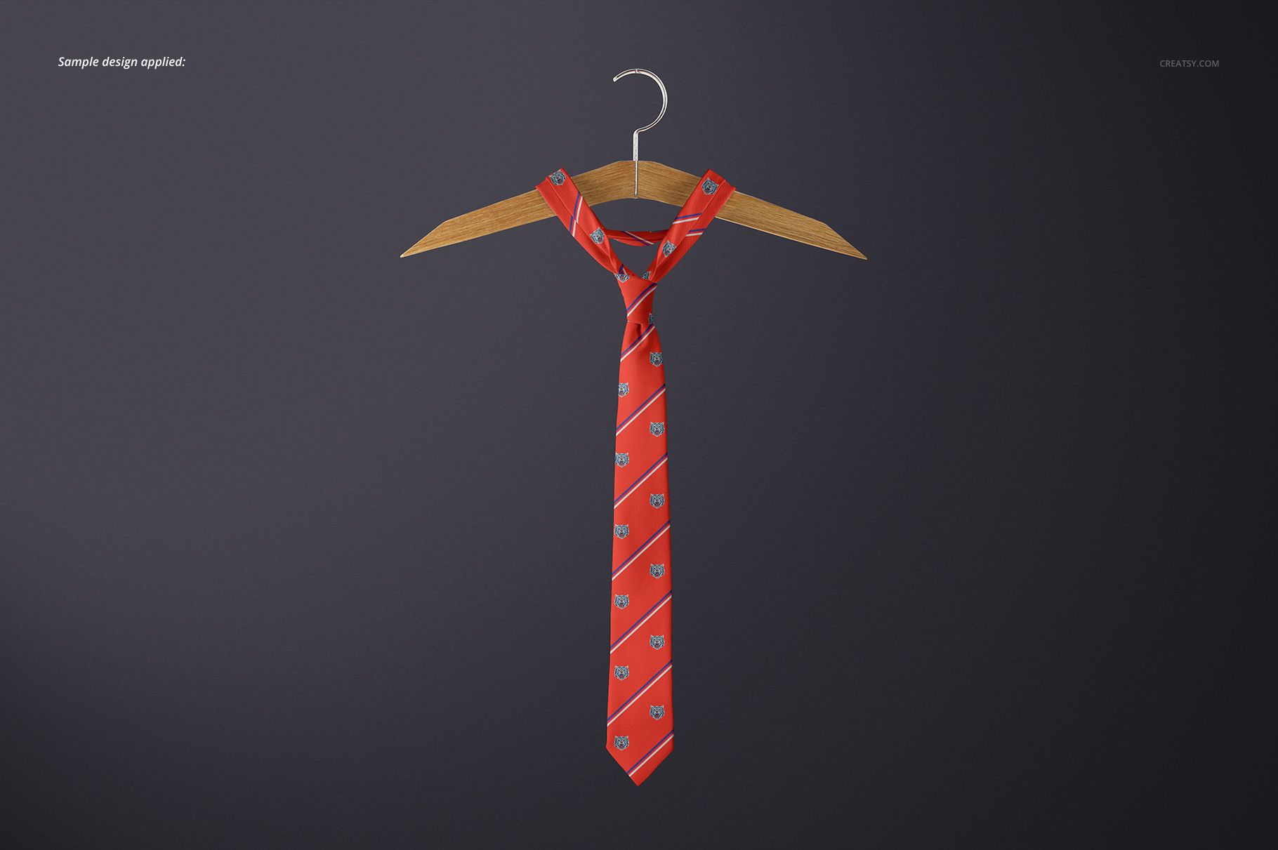PSD mockup showing a red necktie with repeating motifs, arranged on a hanger with a simple dark background.