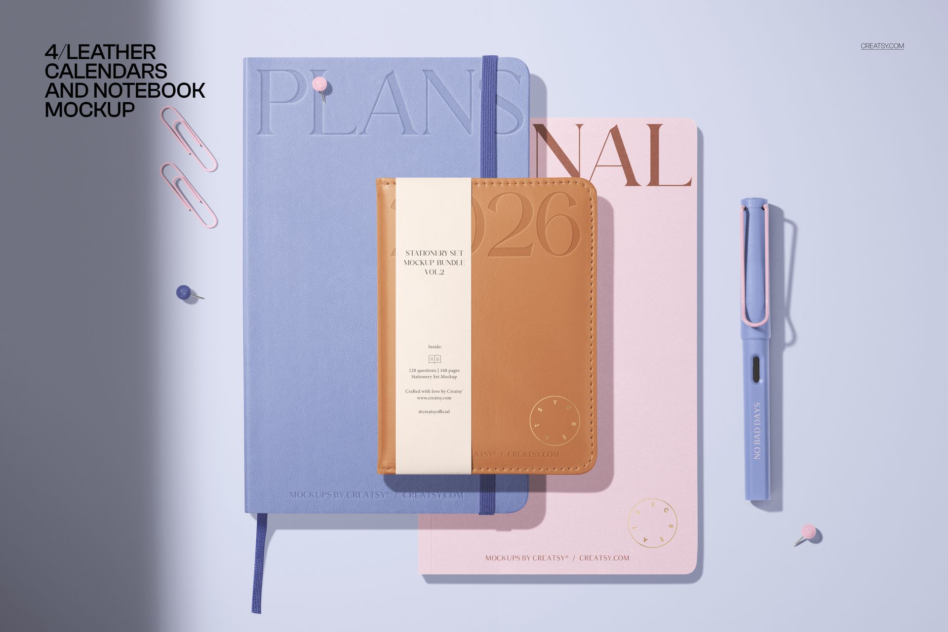Stationery PSD mockup showing pastel-colored notebooks, a tan leather planner, pen, and paper clips arranged neatly.