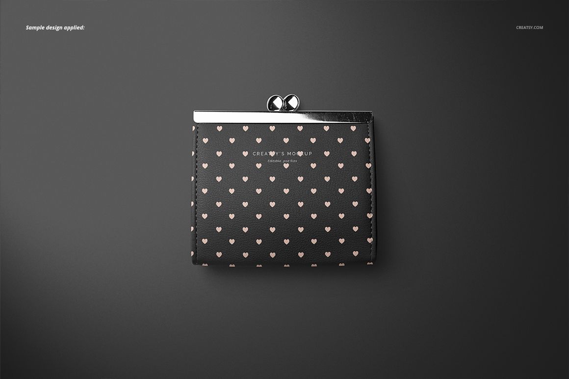 Front view of a leather wallet purse mockup with a repeating pink heart pattern on a dark background, placed on a gray surface.